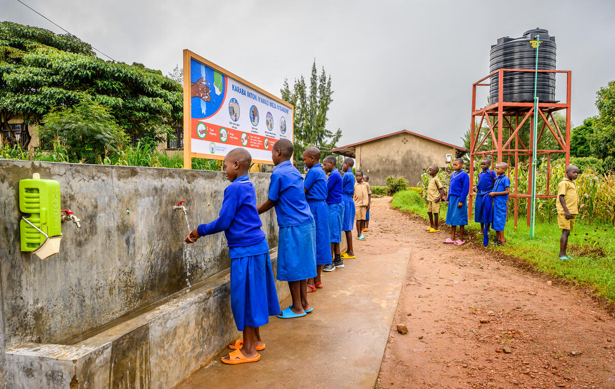 Students washing their hands at a handwashing station.