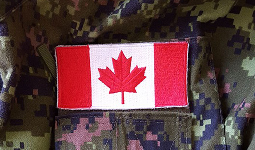 close up of canada flag patch sewn onto camo jacket