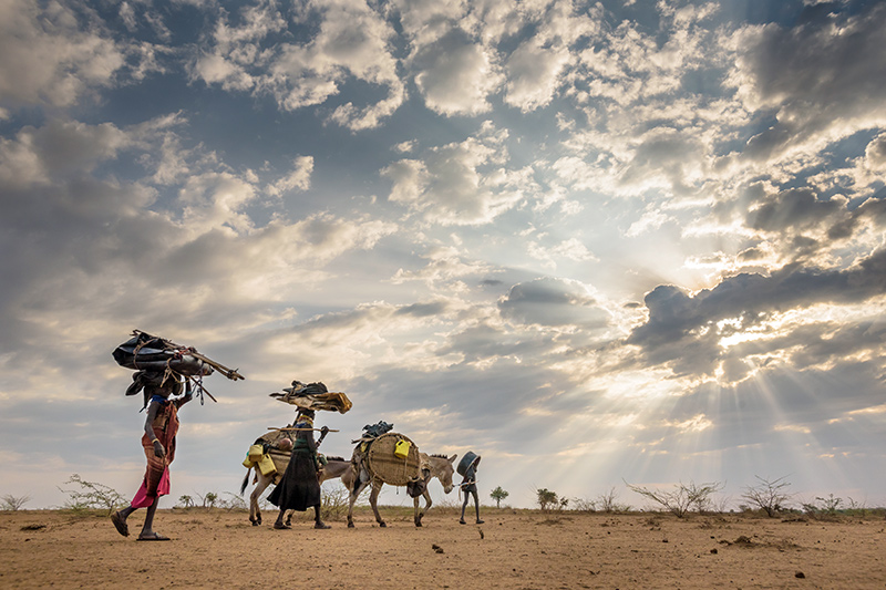A family migrates across Kenya with their belongings.