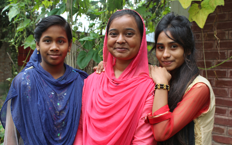 Three Bangladeshi girls smile for the camera
