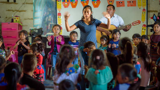 World Vision staff gathered children in the classroom for a sing and dance activity.