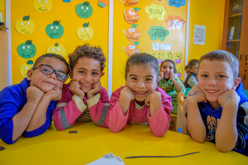 Children smiling for the camera during an activity class