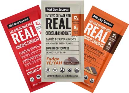 Three flavors of Mid-Day Squares real chocolate bars in red, beige and orange packaging.