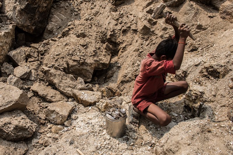 a young boy mines for mica in India