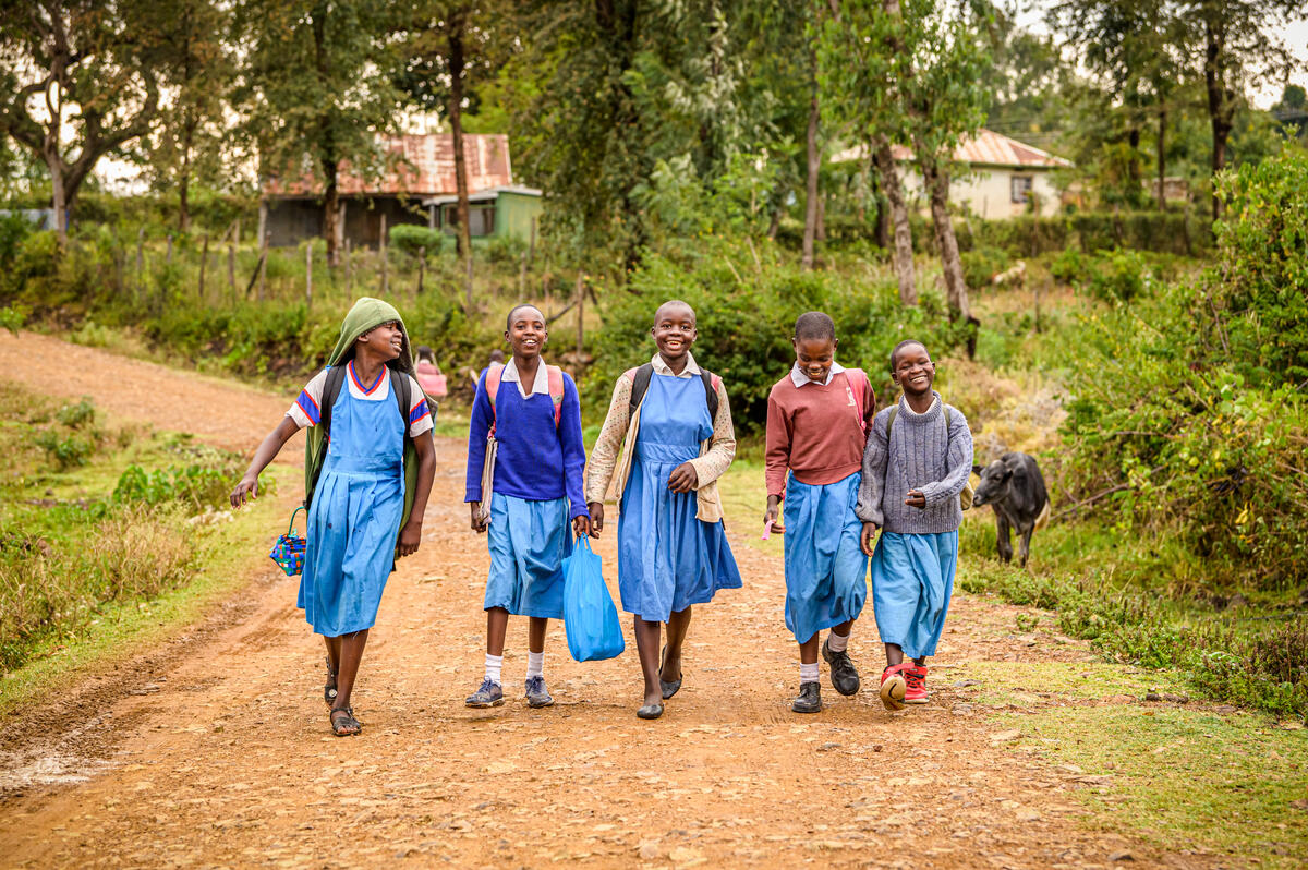 A group of school children headed home after class.