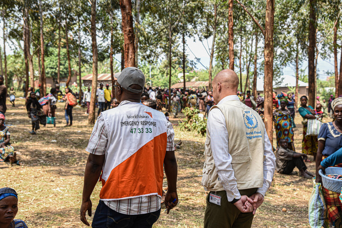 A World Vision and World Food Programme staff walking together.