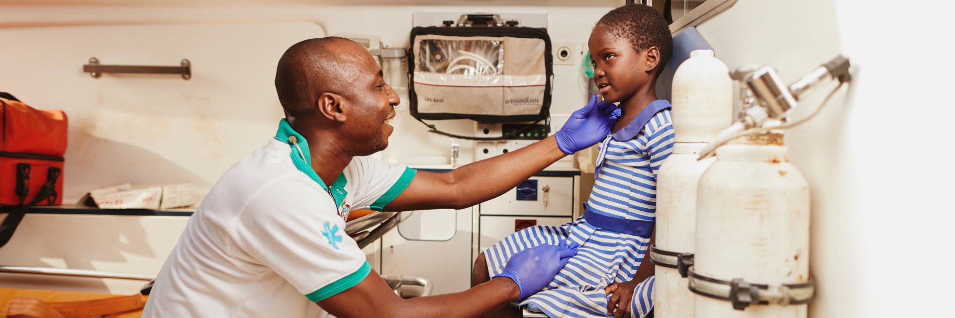 A health worker and young girl in a health clinic.
