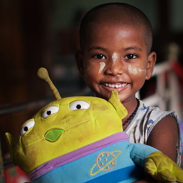 A sponsored child holding a stuffed toy.