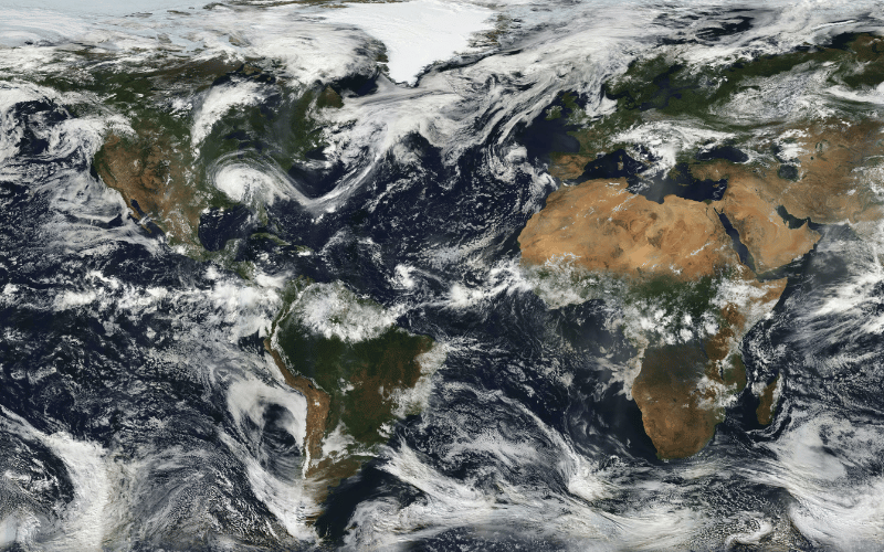 Satellite image of the global map, with white swirls of clouds scattered across the landscape.