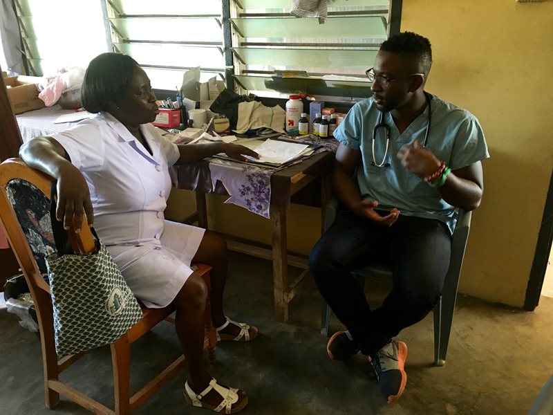 Tolu meeting with a health professional during a trip to Ghana