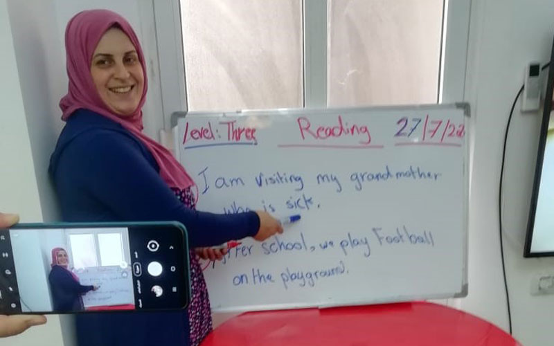 a Jordanian woman stands at whiteboard