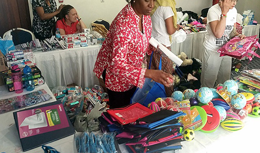 Volunteers sort and organize gifts for children in Tanzania