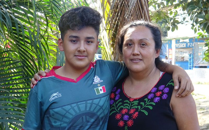 a young Mexican boy poses with his mother.