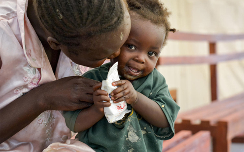 A woman from South Sudan feeds her child.