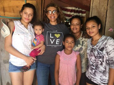 A World Vision staff member with a Venezuelan family.