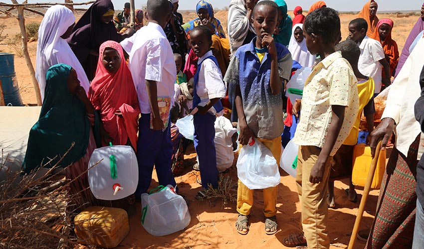In Somalia, school children's lessons are paused while they wait for the water truck to arrive.