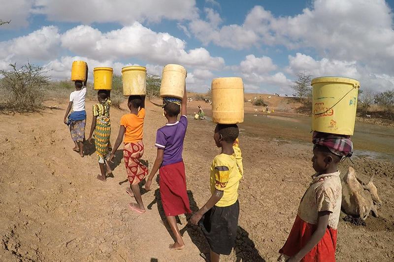 Girls collecting water.