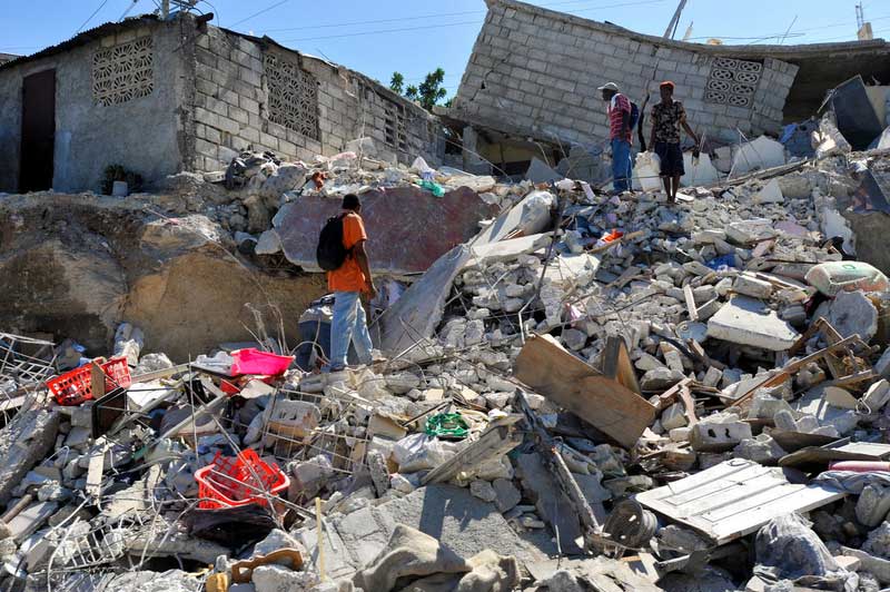 People survey ruins of homes destroyed by the earthquake in Port-au-Prince in 2010.