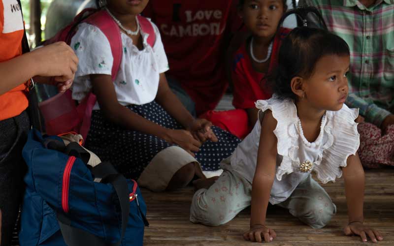 In Cambodia, children sit on the floor.