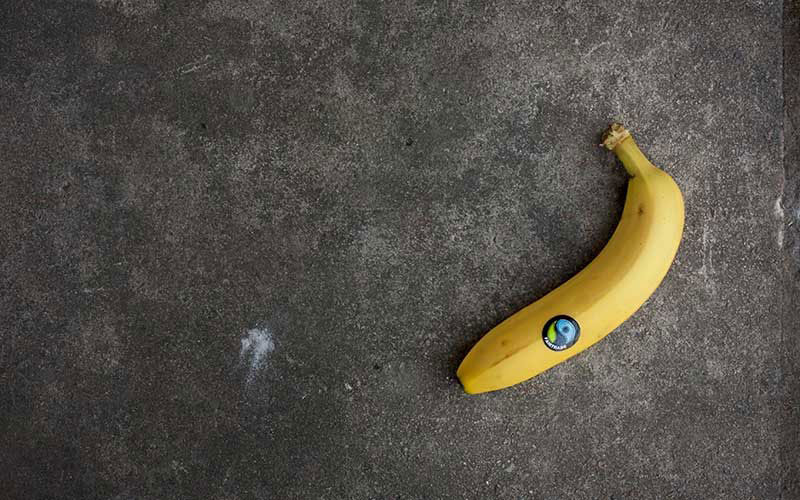 Banana on top of a black background.