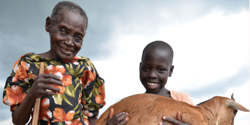 80-year-old Amelia and her granddaughter Susan, 10. The two received goats through the World Vision Gift Catalogue. Photo: Moses Mukitale