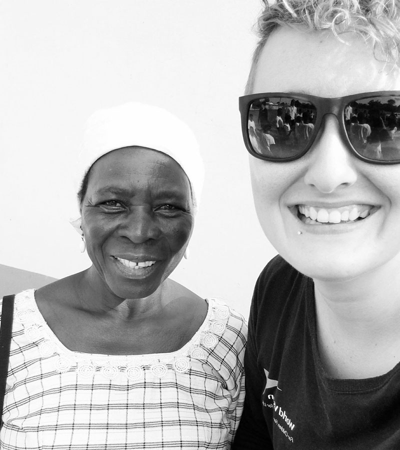 Black and white photo of a Ghanaian teacher and a Canadian sponsorship ambassador