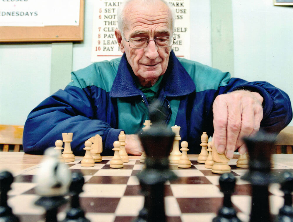 Arie playing chess in a chess club, 2013