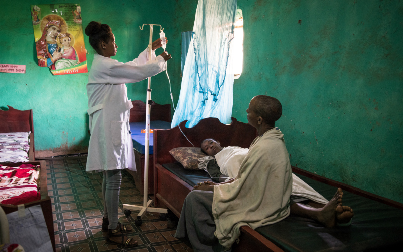 A midwife fixes a patient's IV at a clinic in Ethiopia.