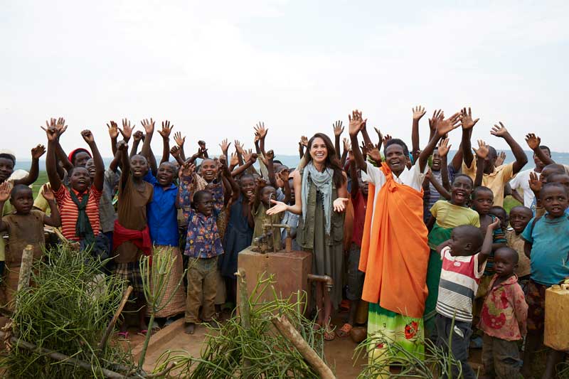 Meghan Markle celebrate with a group of children in Rwanda.