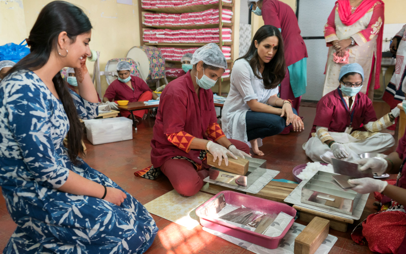 Meghan Markle visits with women in a workshop in India
