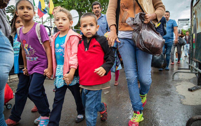 Venezuelan children walk across the border into Colombia.