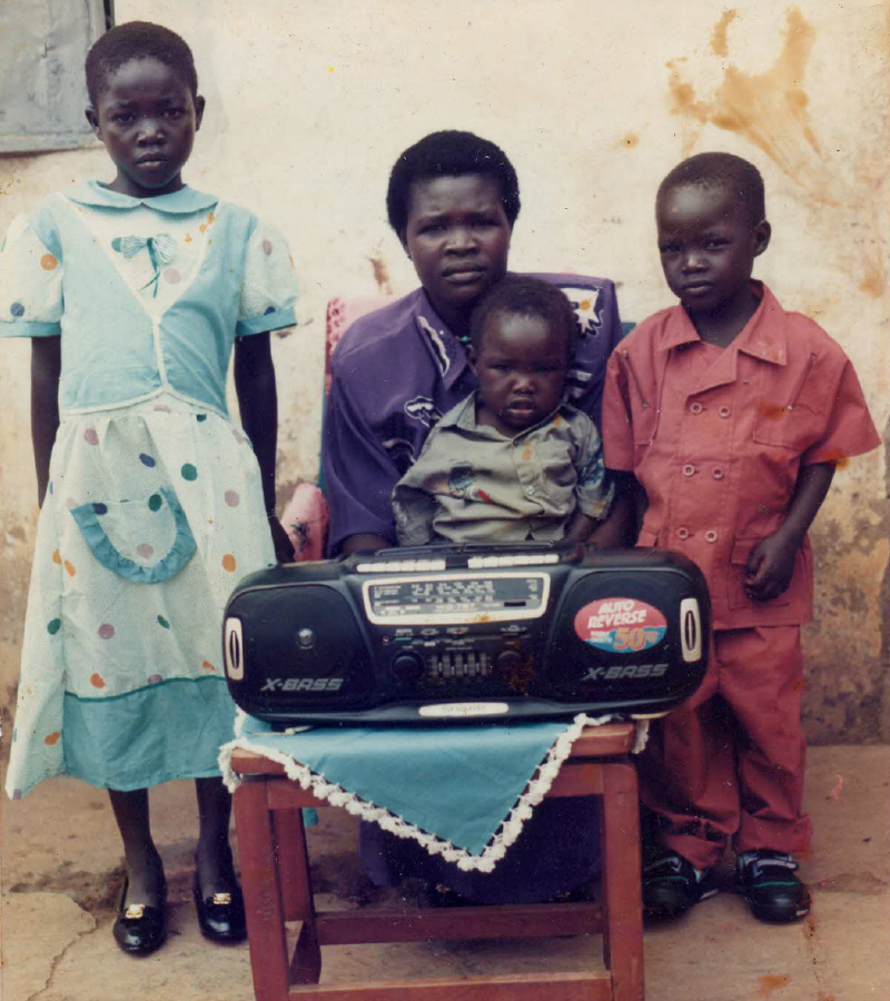 A young girl with her mother and brothers
