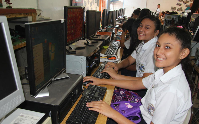 Female students inside a computer laboratory at school.