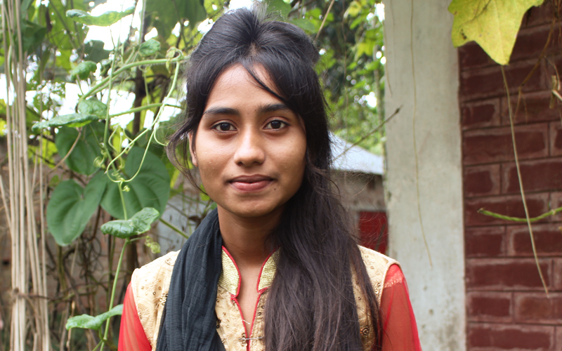 A young Bangladeshi girl smiling for the camera