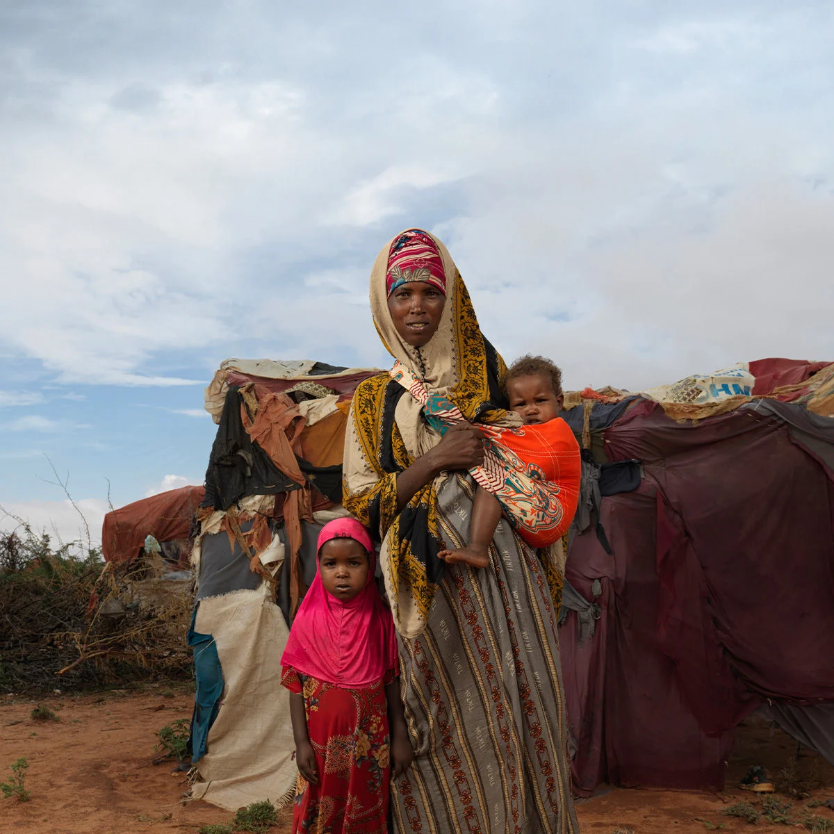 A woman with her two children near a make-shift tent in a drought-affected area in Somalia.