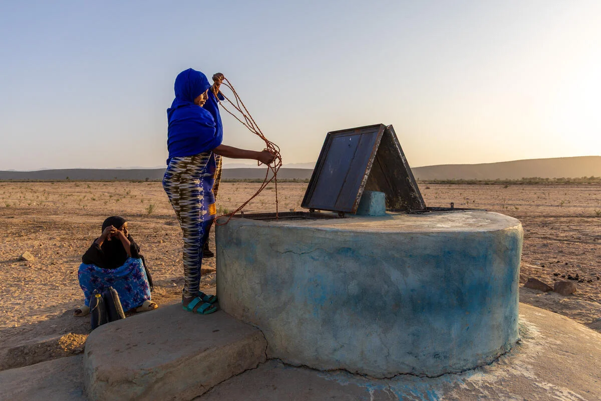 A women in Somalia retrieving water from a well.
