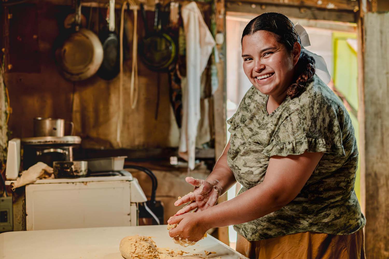 Lisbeth, Youth Ready Graduate and now Youth Ready Trainer, baking in her home
