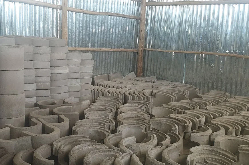 Moulded components of energy-efficient cookstoves are stored indoors.