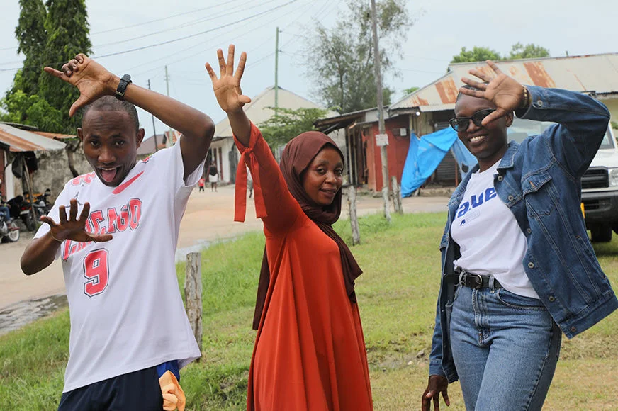 Three adolescents pose for the camera.