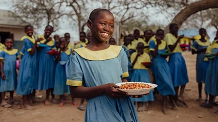A woman receives a sanitation kit from a World Vision Canada worker.