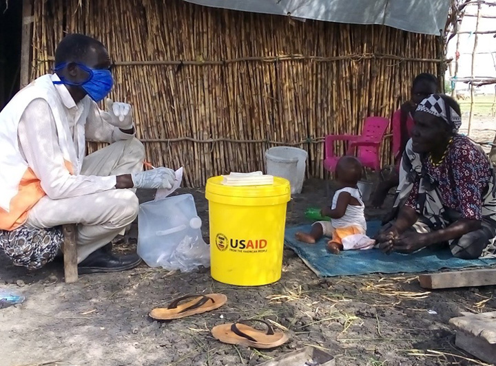 A male staff member talks to a community member of Kodok in South Sudan.