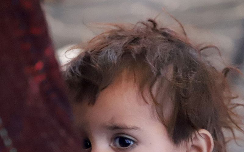 Cropped photo of a small child, showing only eyes and hair.