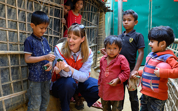 A World Vision staff worker meets with children in Bangladesh.