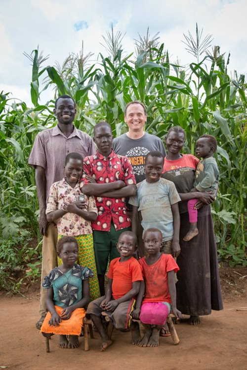 Michael Messenger with a refugee family in Uganda